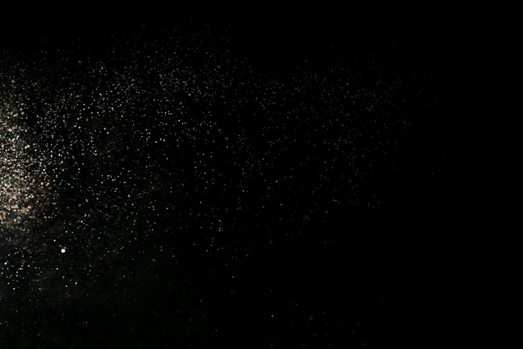 White Dust Particles on Black Background